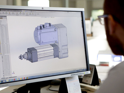 Metalwork employee drawing a 3D object on computer
